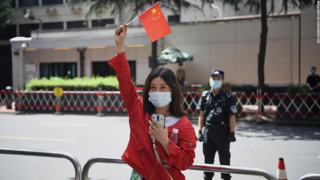 Policemen march in front of the US consulate in Chengdu, southwestern China's Sichuan province, on July 26.