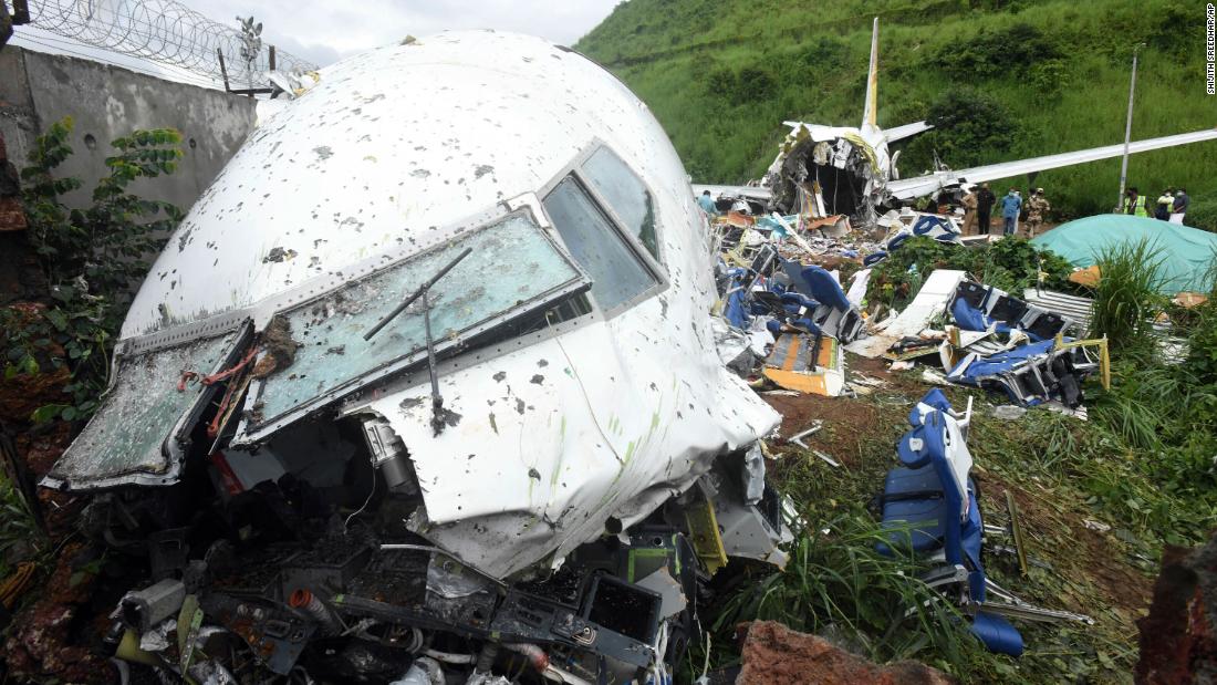 A man walks near the wreckage of the Air India Express plane on Saturday.