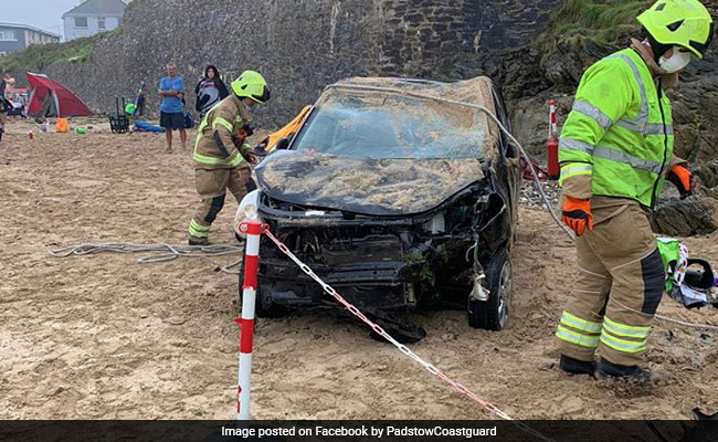 Onbeheerste auto stort naar beneden van 6 meter hoge klif, landt op druk strand