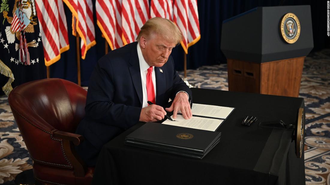 US President Donald Trump signs executive orders extending coronavirus economic relief, during a news conference in Bedminster, New Jersey, on August 8, 2020. - Trump signed the executive orders after his Republican party and opposition Democrats failed to reach agreement on a new stimulus package. "We've had it and we're going to save American jobs and provide relief to the American workers," he said at a press conference staged at his golf club in Bedminster, New Jersey. (Photo by JIM WATSON / AFP) (Photo by JIM WATSON/AFP via Getty Images)
