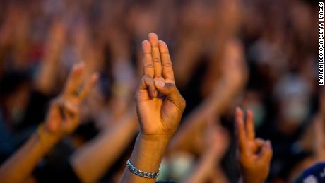 Demonstranten geven een groet met drie vingers tijdens een bijeenkomst bij Democracy Monument op 16 augustus 2020 in Bangkok.